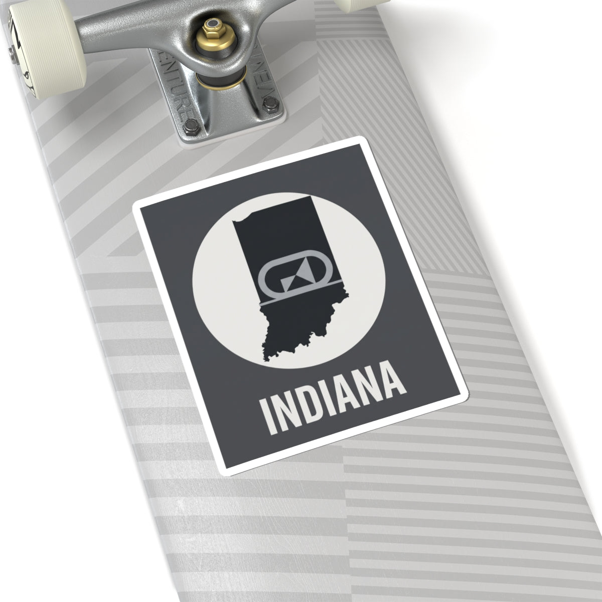 Indiana sticker on gray striped surface, black badge emblem and “INDIANA” text