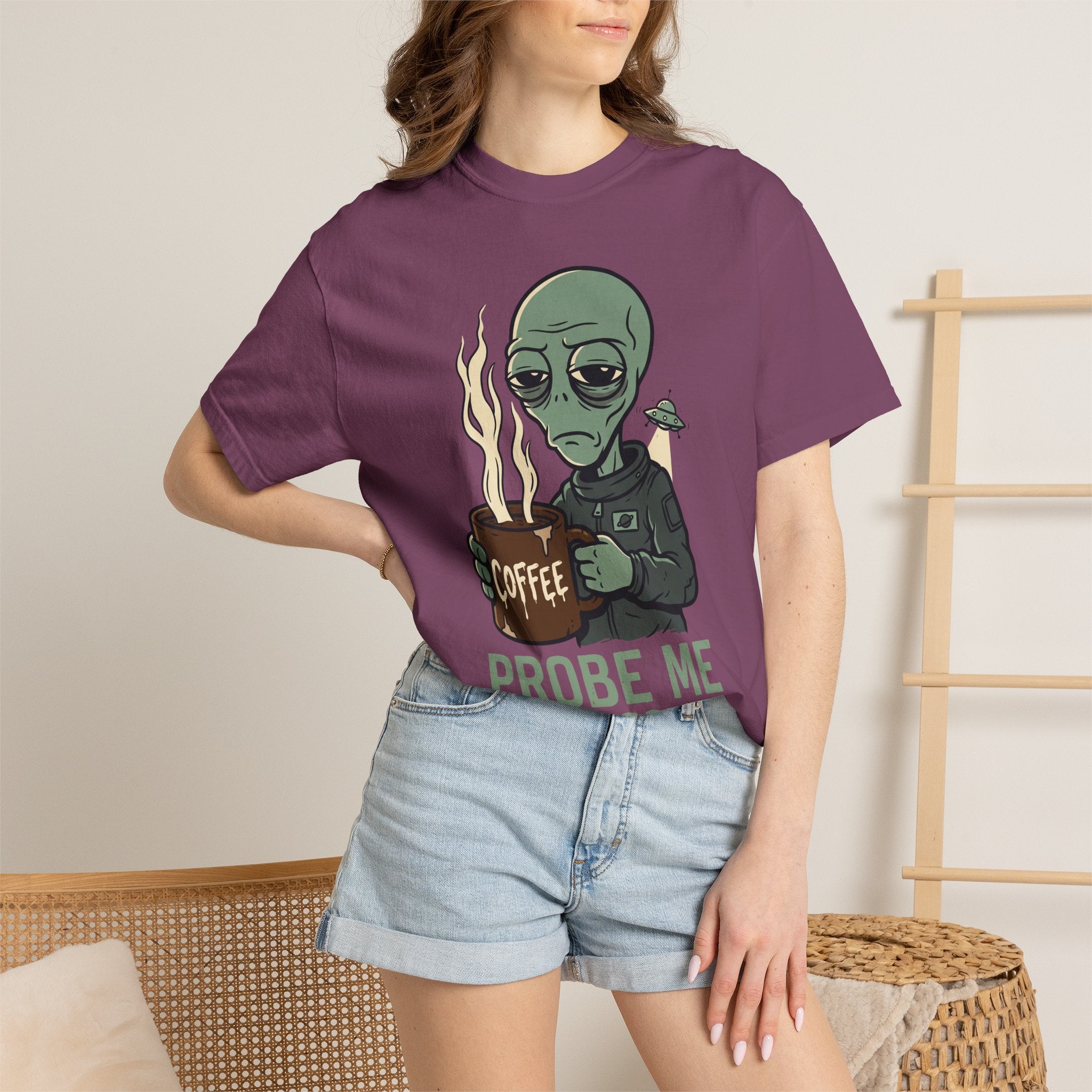 Dark purple T-shirt on model with green alien holding coffee and “PROBE ME” print