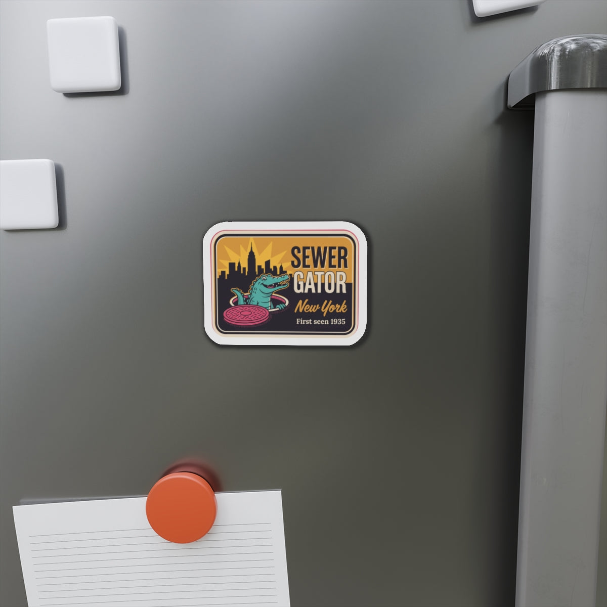 Die-cut refrigerator magnet on stainless fridge door with Sewer Gator New York artwork.