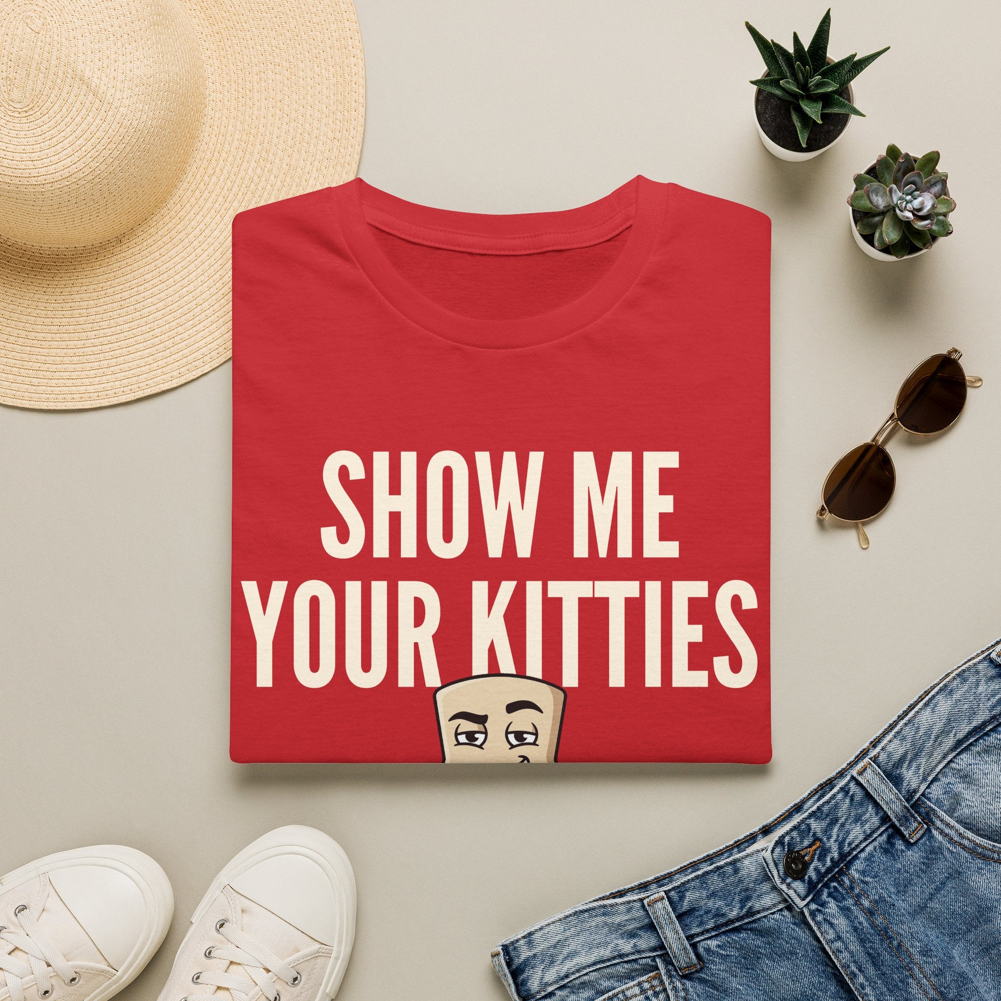 Red T-shirt with “SHOW ME YOUR KITTIES” cat graphic on the front.