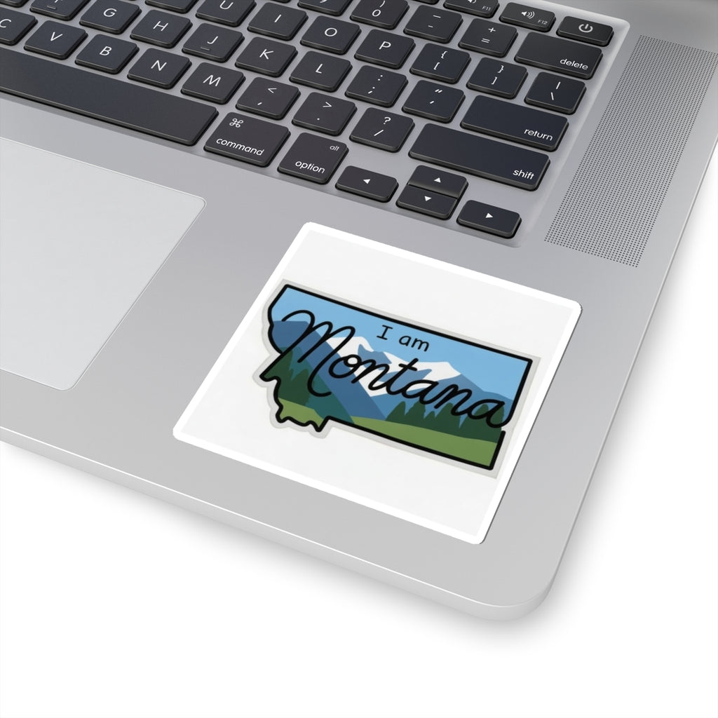 I am Montana sticker on laptop lid, blue mountains and green forest graphic