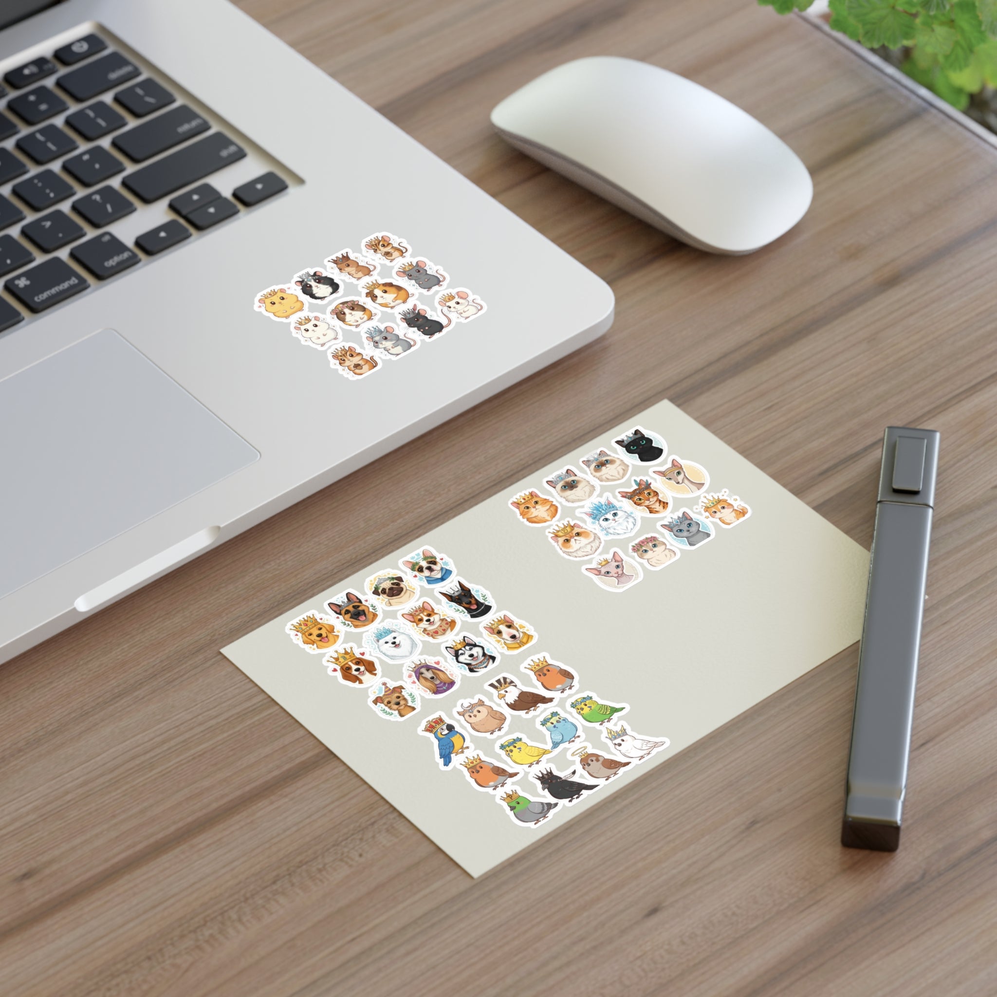 Royal Pets die-cut sticker sheets on desk, near laptop and mouse