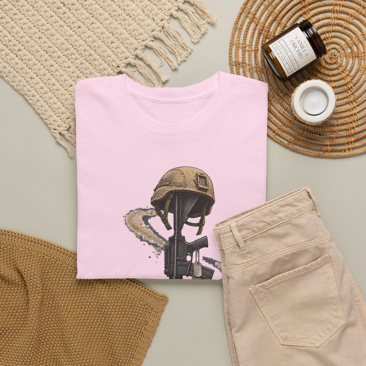 Light pink folded crewneck T-shirt with helmeted soldier and rifle graphic