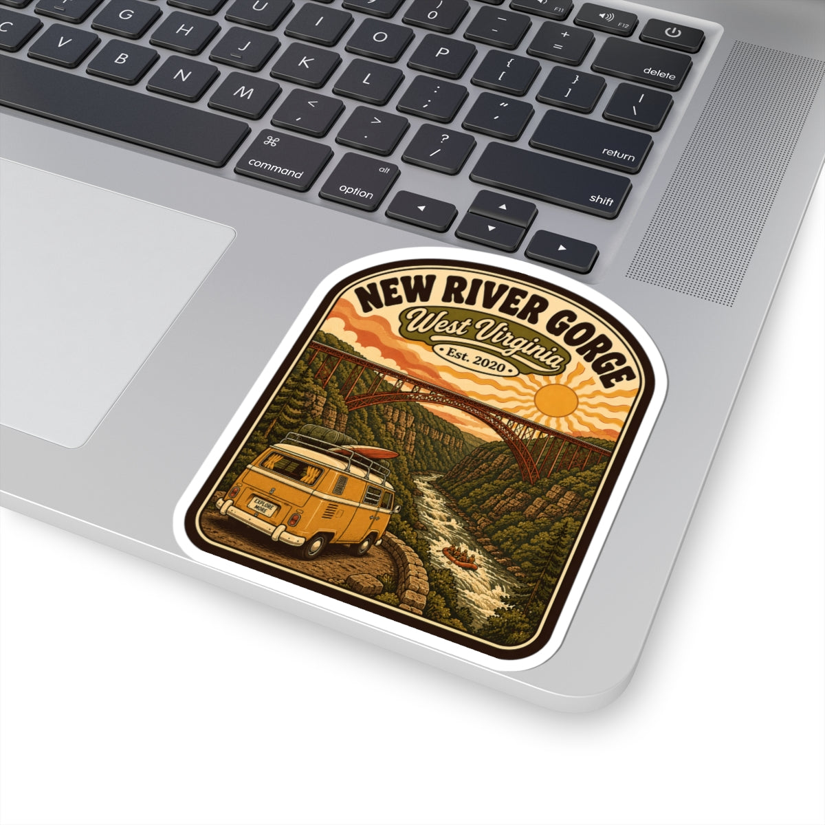 Rounded kiss-cut sticker on laptop, New River Gorge logo and bridge scene