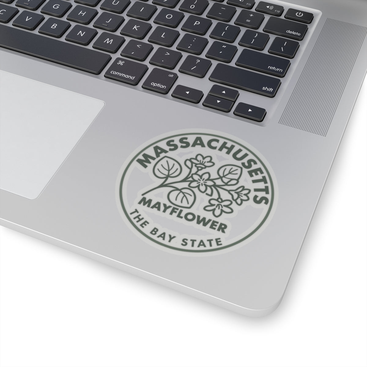 Circular Massachusetts Mayflower state flower decal on laptop lid, gray botanical and lettering
