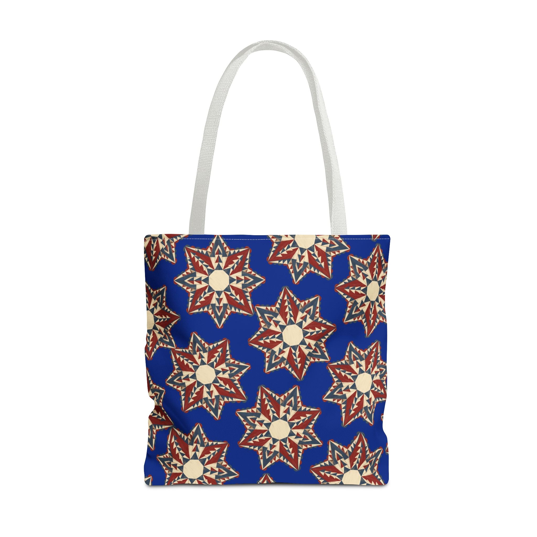 Blue tote bag with starburst floral pattern and pale gray handles