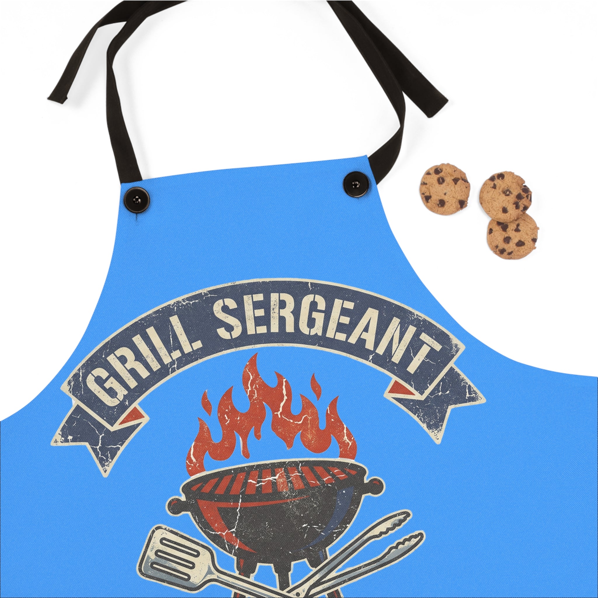 Blue apron front panel with flame and grilling tools badge, black tie straps