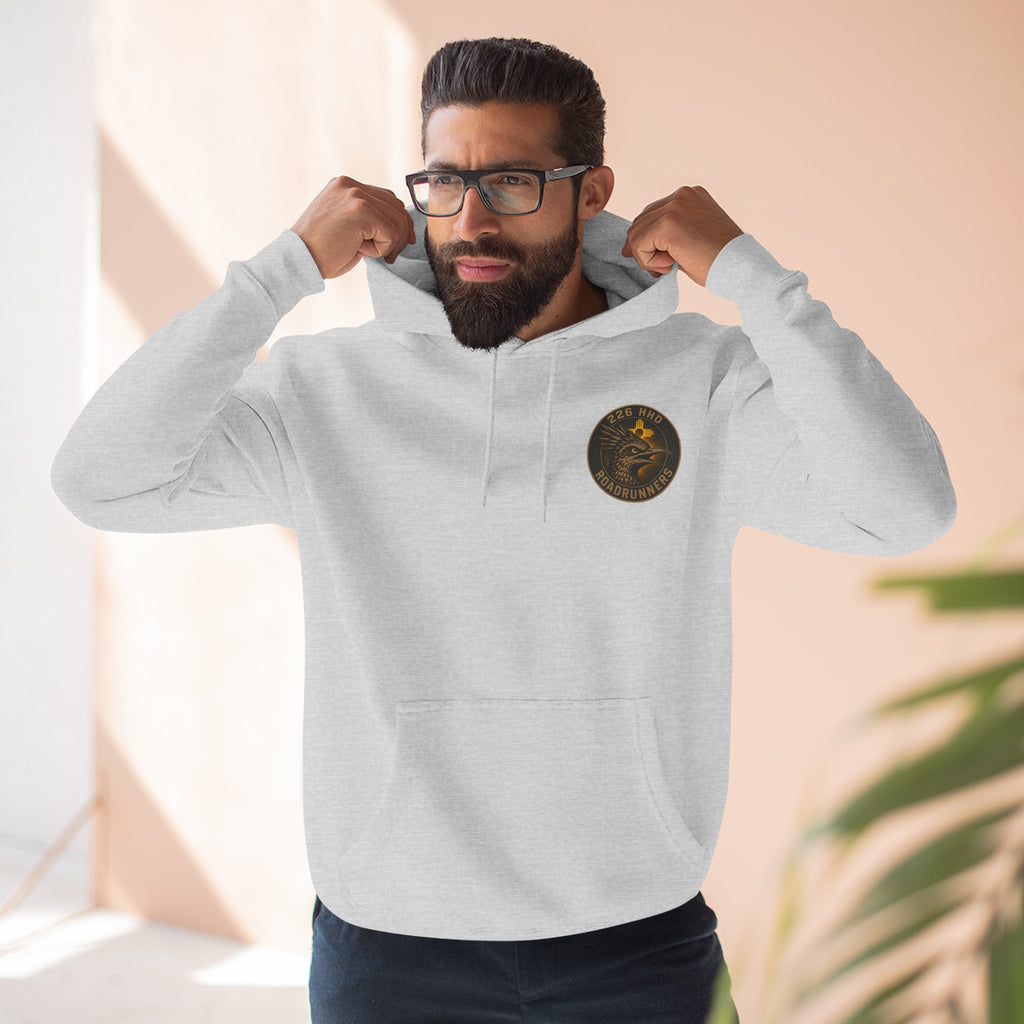 Heather gray pullover hoodie worn by model, front pocket and chest patch visible