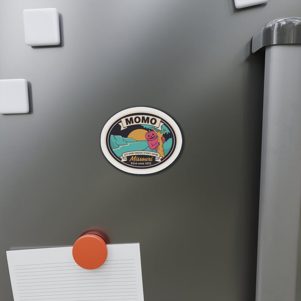 Round Momo roadside magnet on refrigerator surface with jack-o-lantern and Missouri text