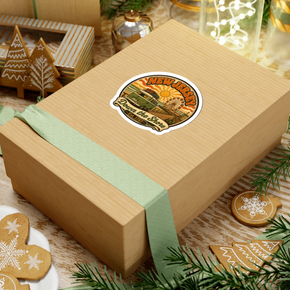 Round sticker on a wrapped gift box, with New Jersey beach artwork, van, and ferris wheel.
