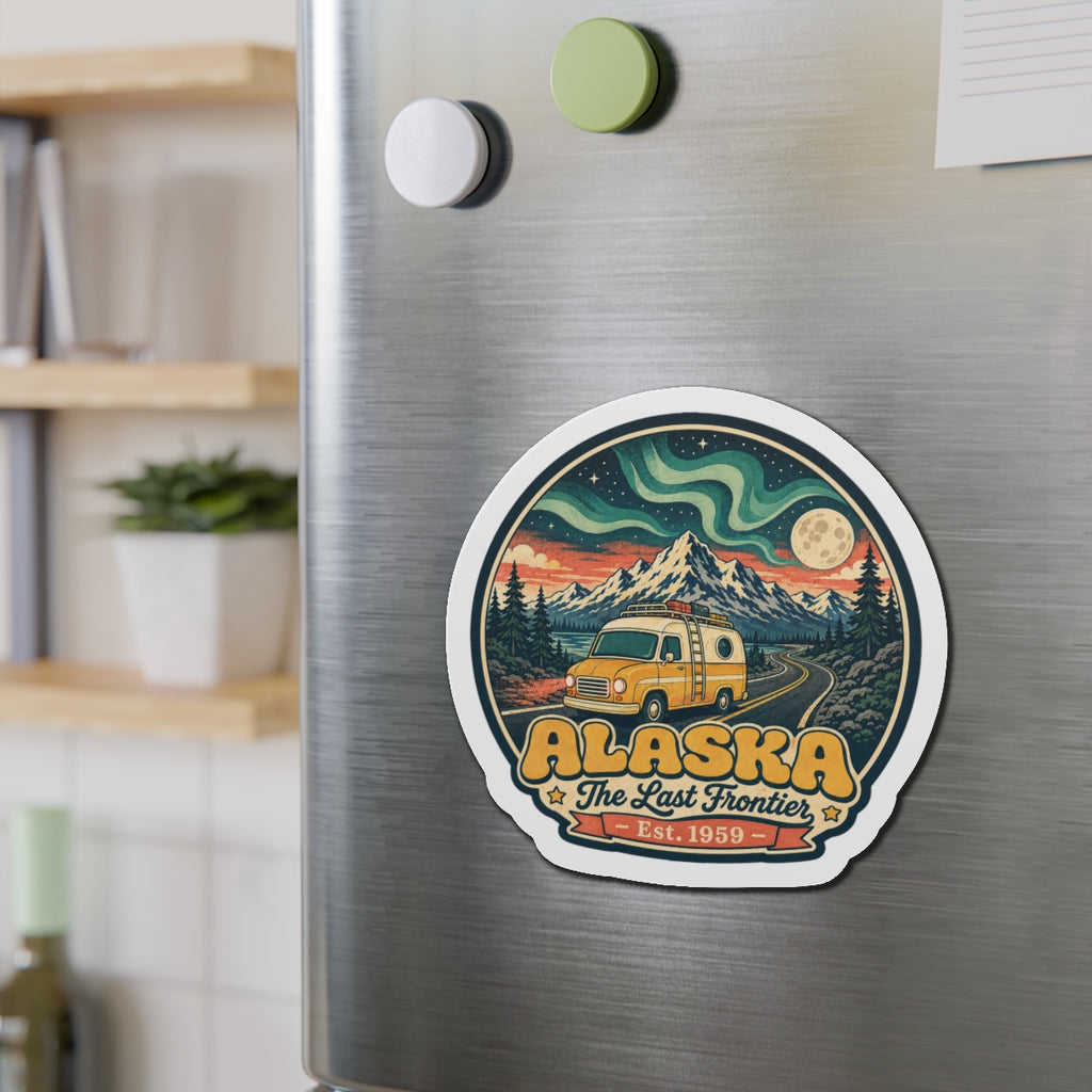 Die-cut Alaska magnet with yellow van, pine forest, night sky swirls, and moon