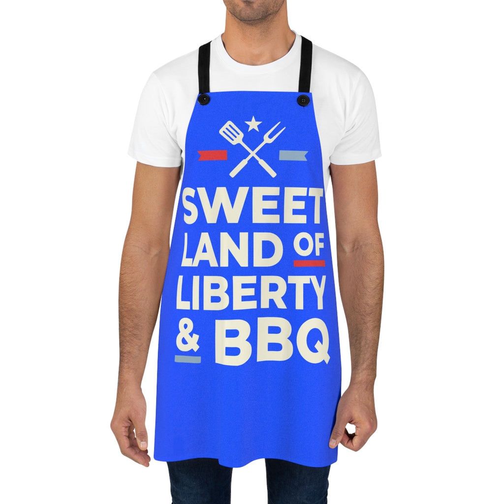 Blue BBQ apron worn by man, 'Sweet Land of Liberty & BBQ' utensil graphic