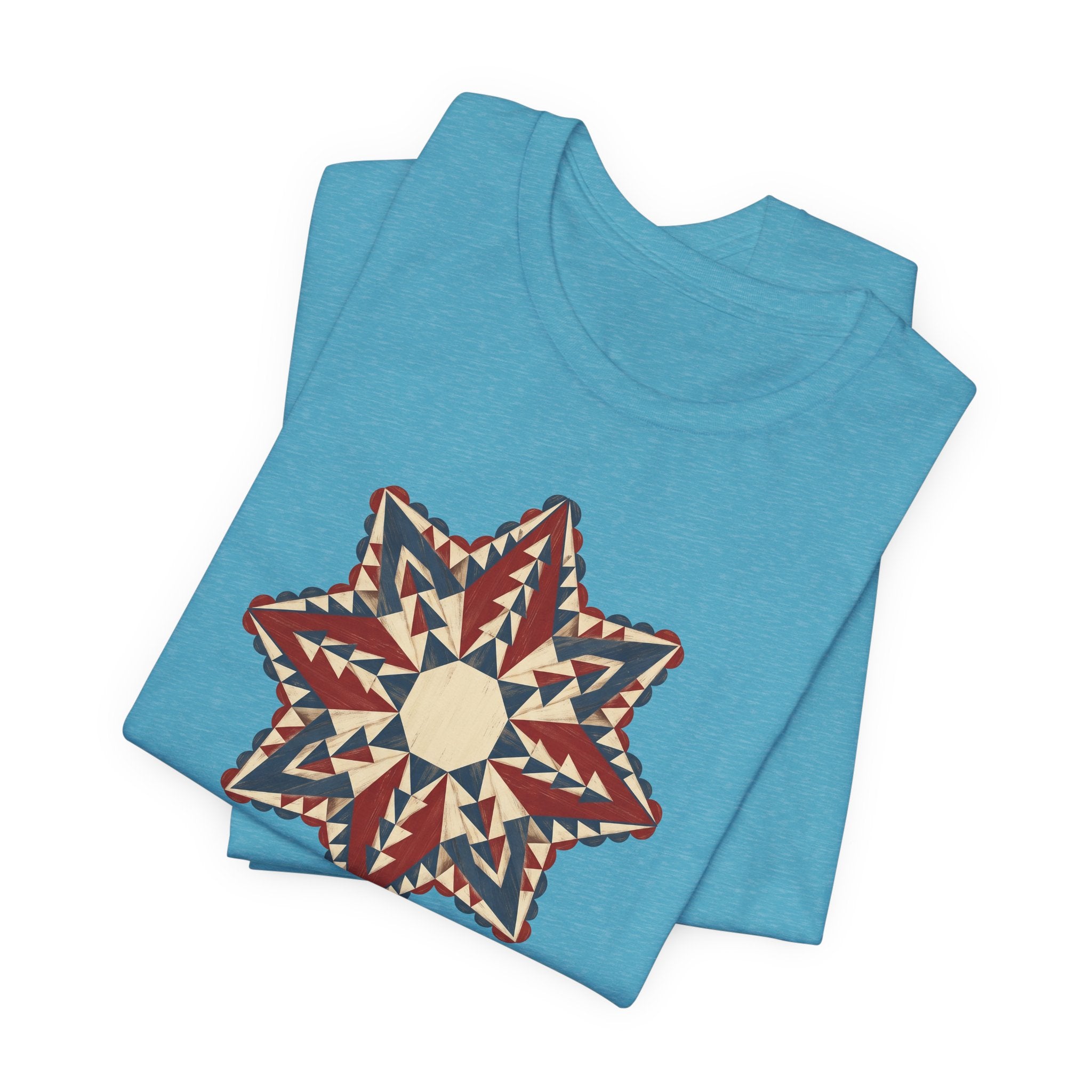Light blue graphic T-shirt with large star mandala print in red, cream, and tan triangles
