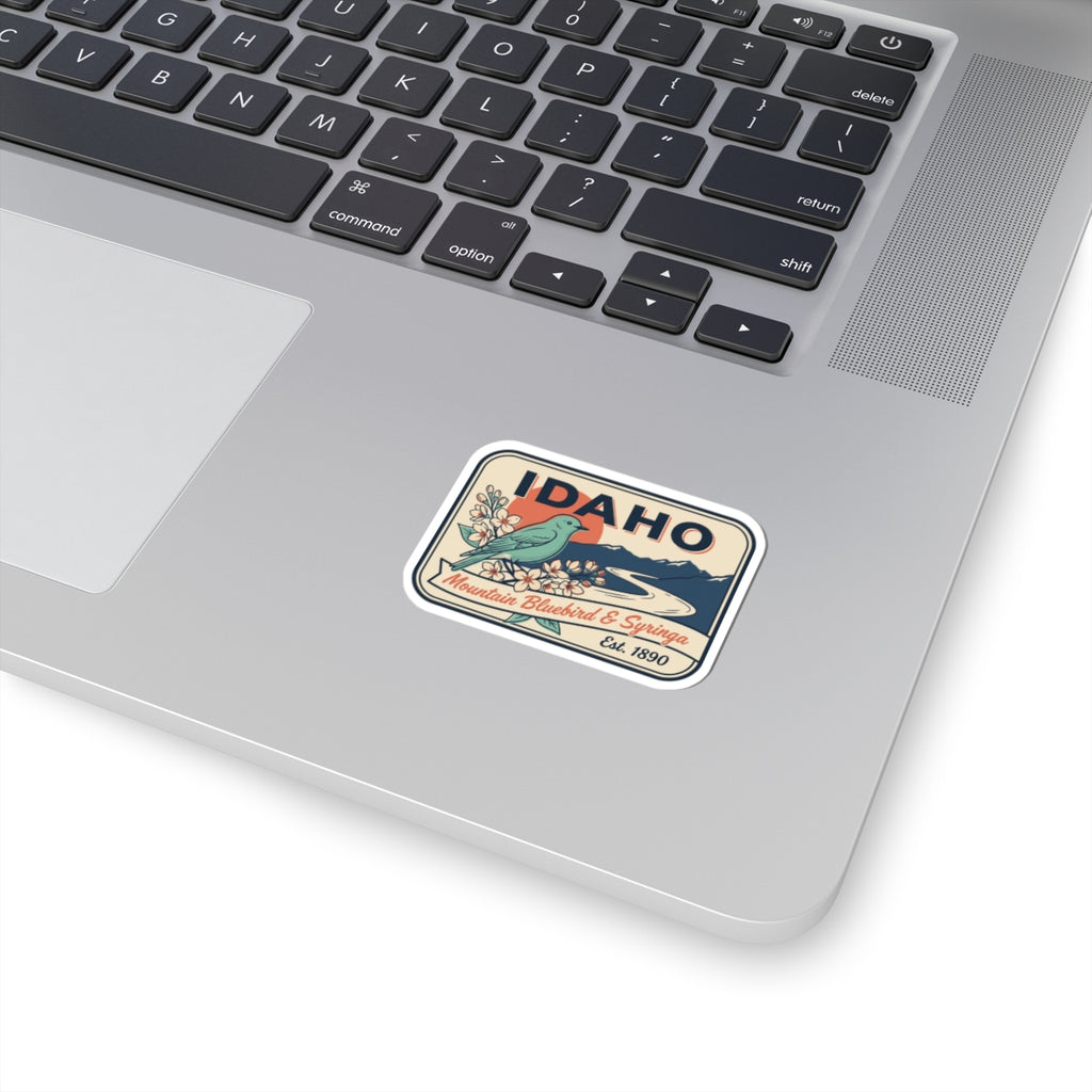 Square vintage Idaho state badge vinyl sticker with blue landscape and banner text