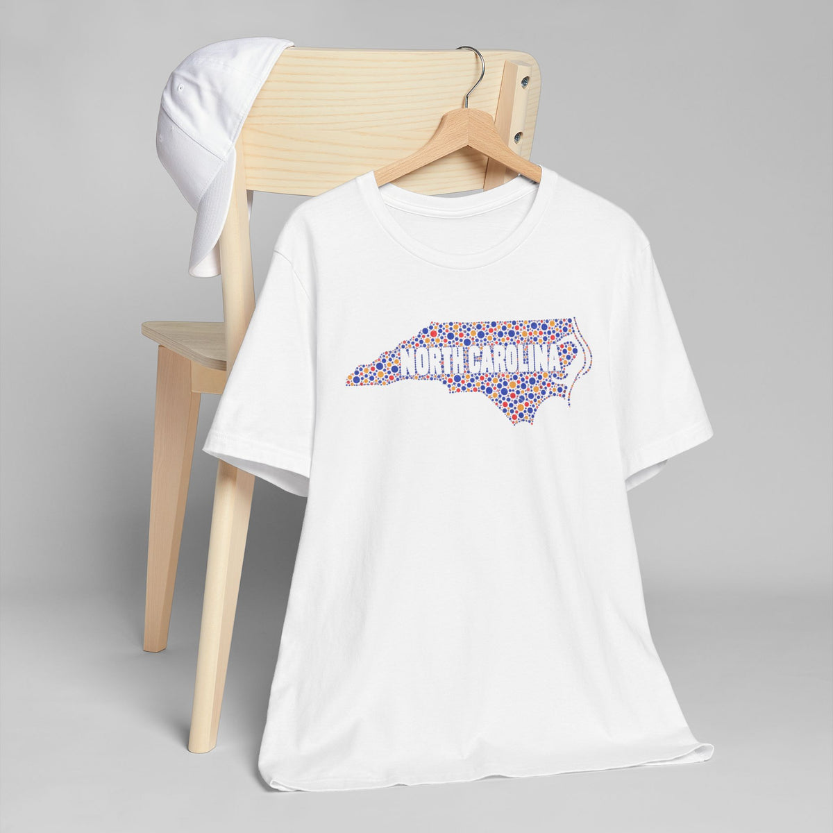 White crew-neck T-shirt with colorful North Carolina floral map graphic