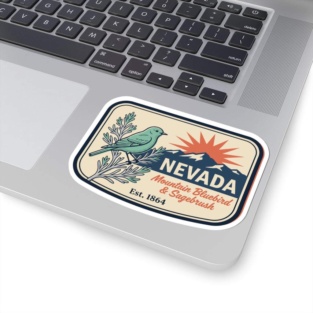 Nevada state badge sticker on a laptop, with bluebird, sagebrush, mountain ridge, Est. 1864.
