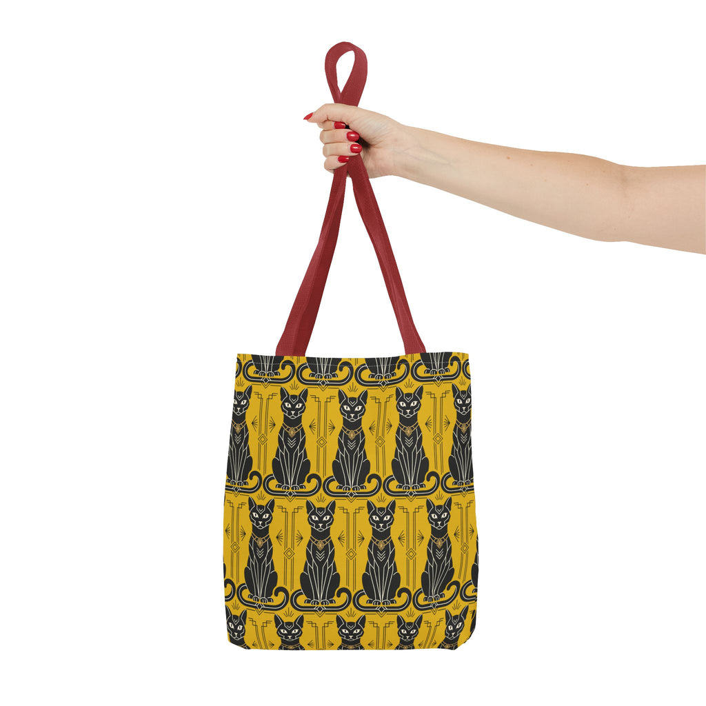 Yellow tote bag with black Art Nouveau cat pattern held by red top handles