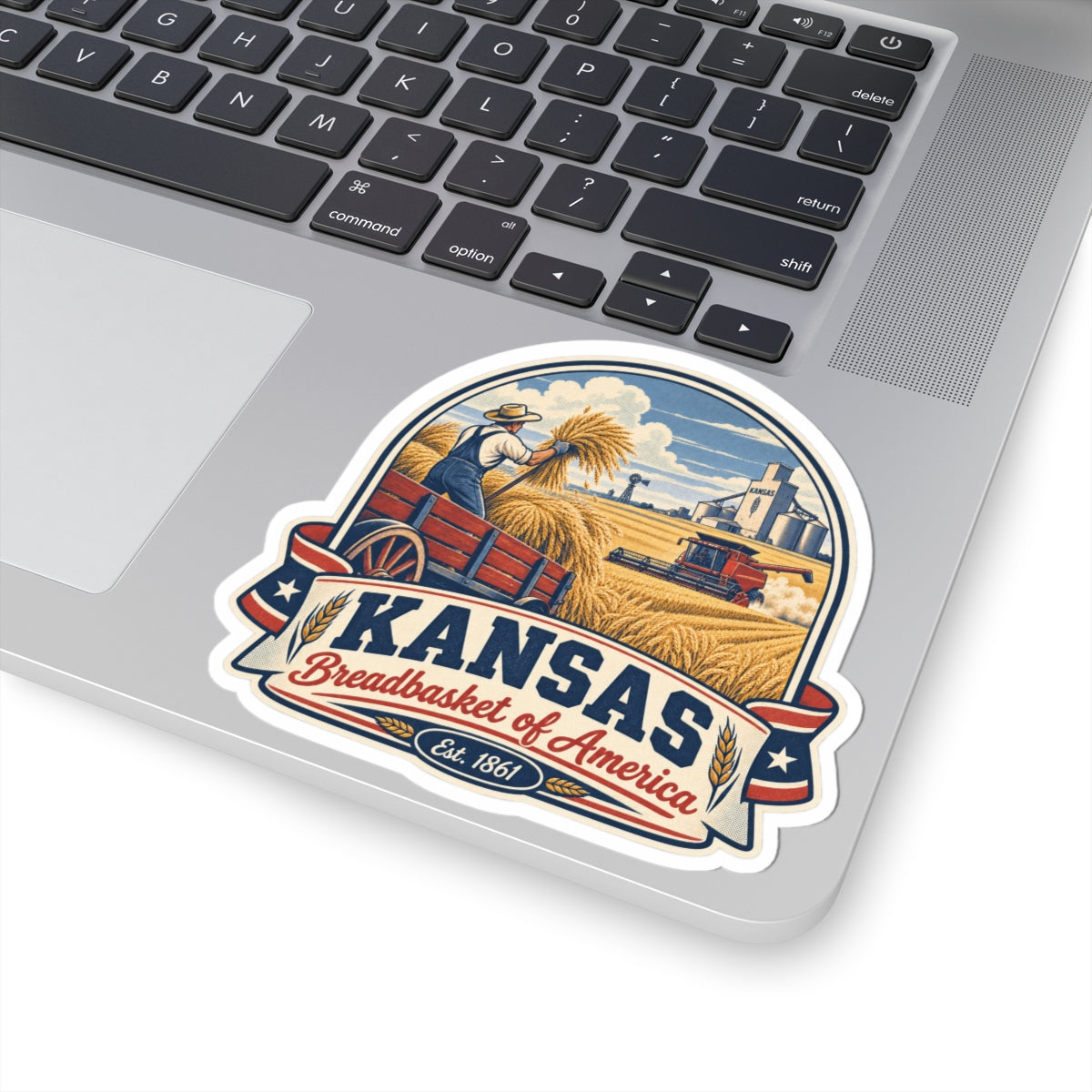 Kansas vintage harvest sticker on a laptop keyboard, showing “Kansas Breadbasket of America”