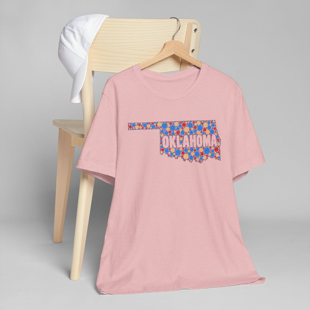 Dusty pink t-shirt with colorful Oklahoma floral map graphic on front.