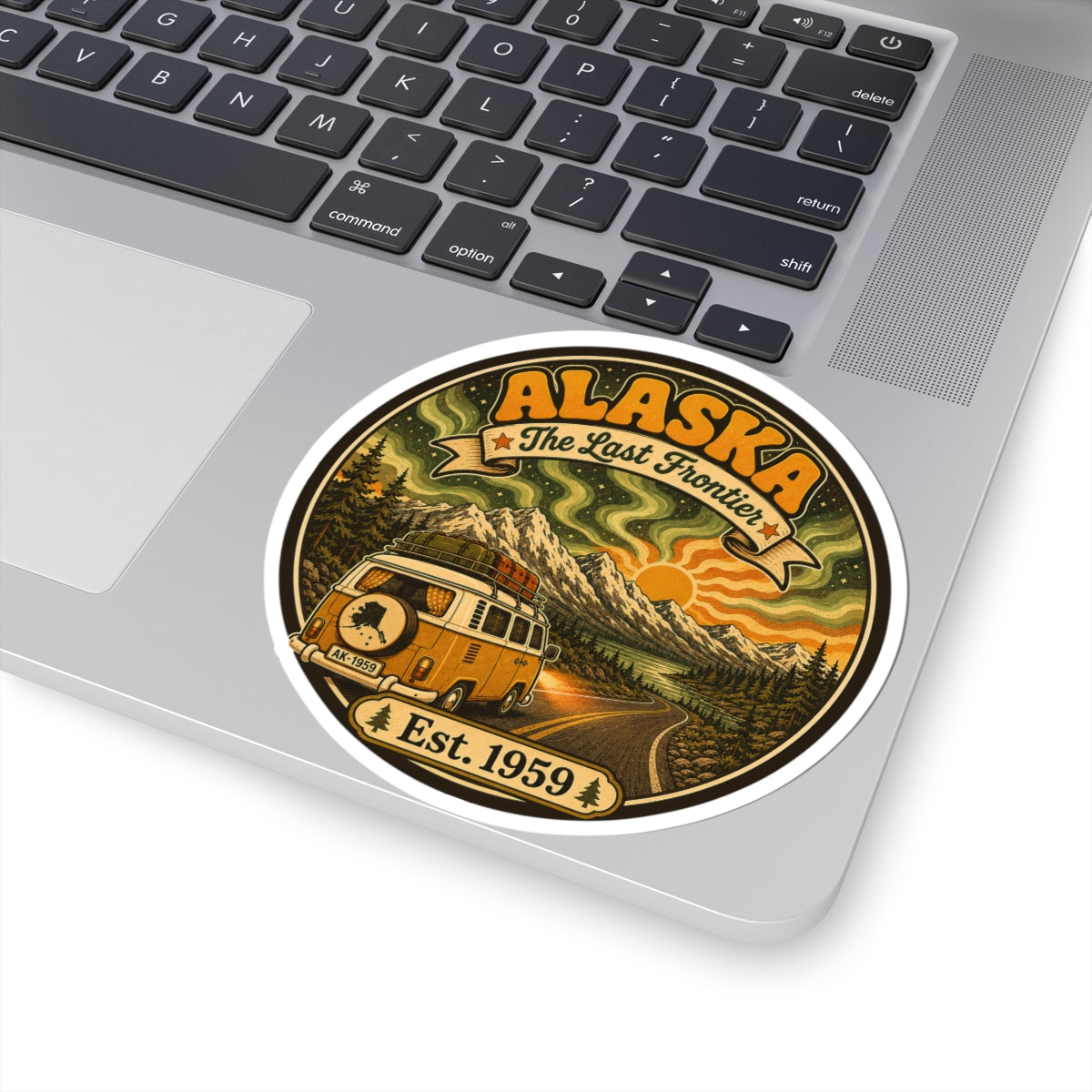 Round Alaska vintage sticker on a laptop lid, with “The Last Frontier” and Est. 1959