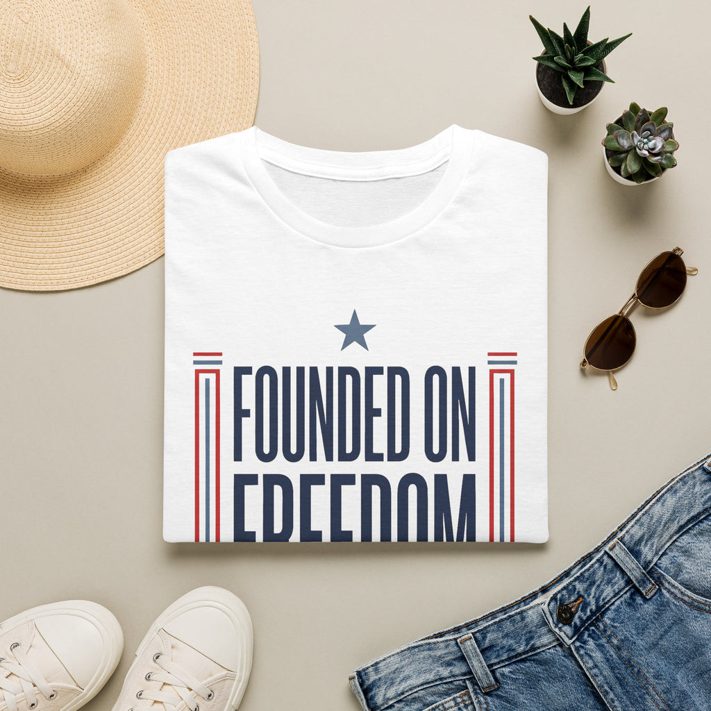 White graphic T-shirt with "Founded on Freedom" text and blue star