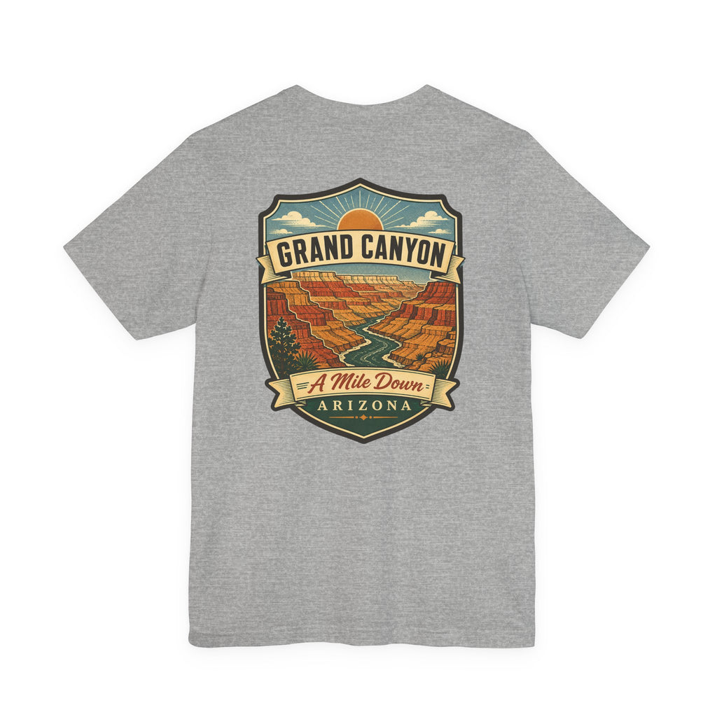 Heather gray crew-neck T-shirt with large Grand Canyon scenic badge graphic reading "A Mile Down"