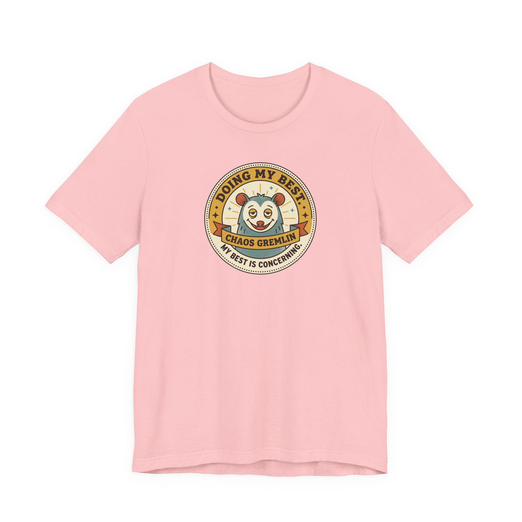 Light pink T-shirt with round cartoon gremlin badge graphic on the chest