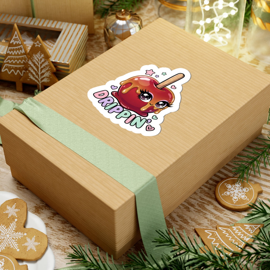 Kiss-cut sticker of a red dripping candy apple character with heart accents on a wrapped gift