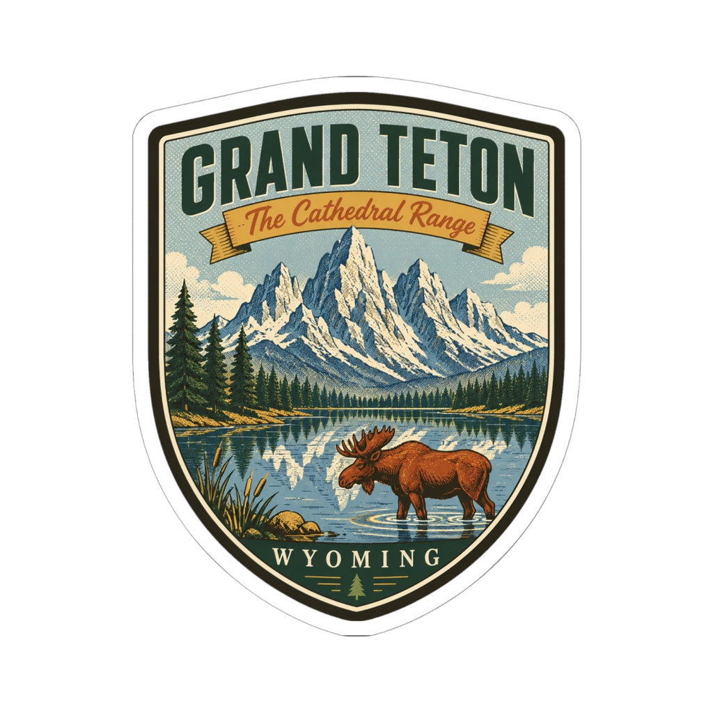 Shield-shaped outdoor travel sticker with moose in the foreground and mountain range background.