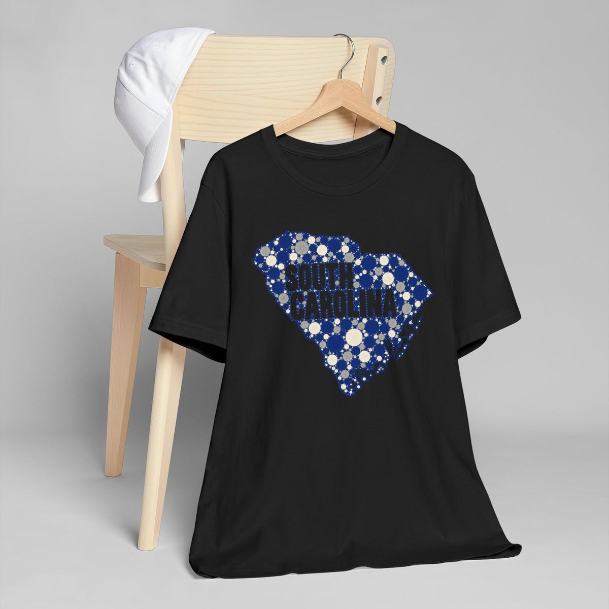 Black T-shirt with blue dotted South Carolina outline and text graphic on front.