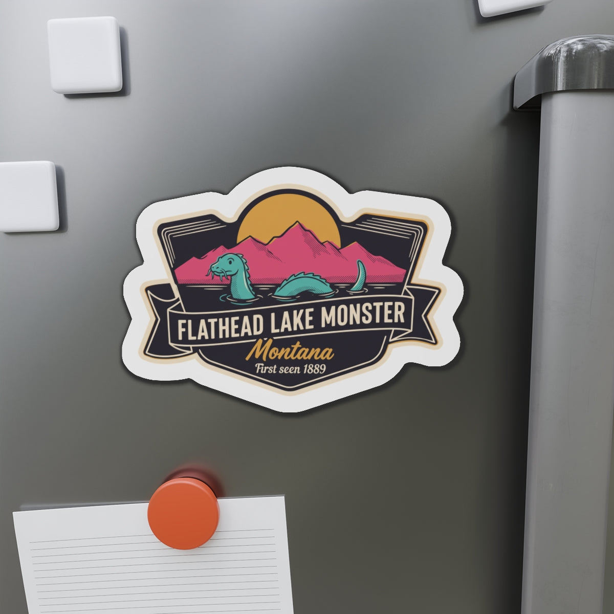 Die-cut magnet badge with Flathead Lake Monster and Montana script on refrigerator