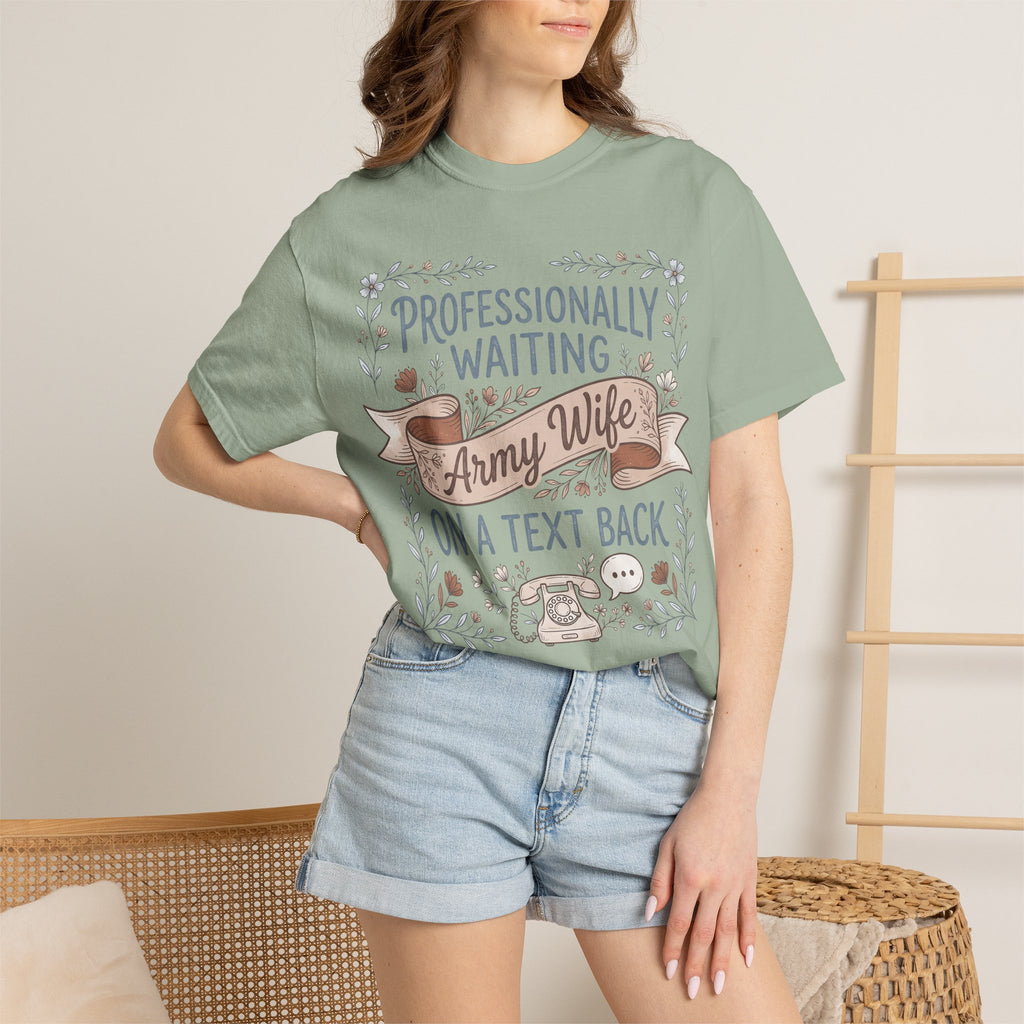 Light green t-shirt worn by model with floral ribbon 'Professionally Waiting Army Wife' text