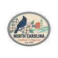 North Carolina state badge sticker showing blue cardinal, flowers, lighthouse, and Est. text