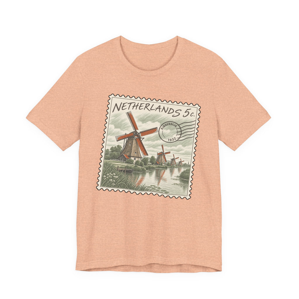 Peach T-shirt with vintage Netherlands postage stamp graphic featuring a windmill and canal