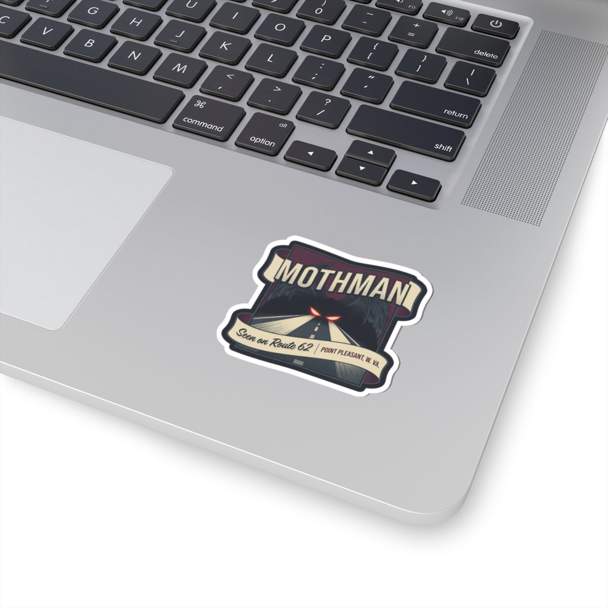 Mothman sticker decal with vintage sign graphic, white border on a laptop