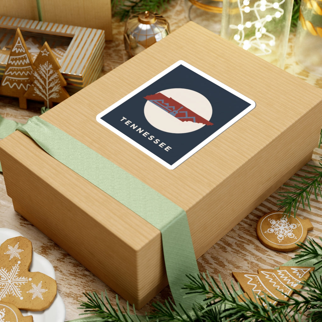 Tennessee outline sticker with retro mountains and guitar detail on a wrapped gift