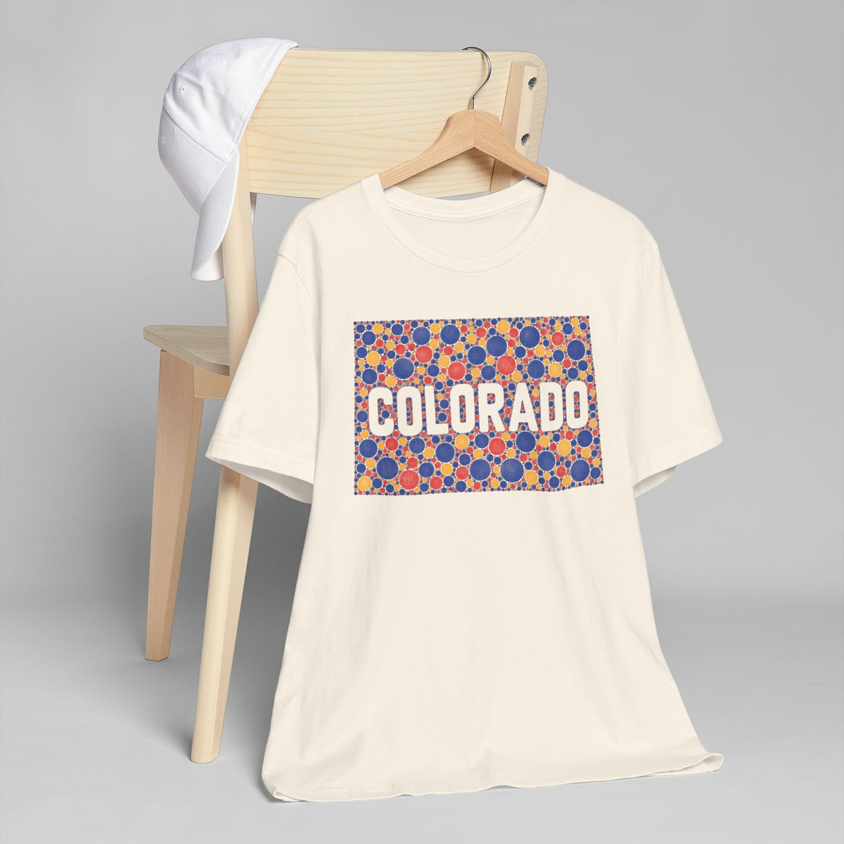 Cream crew-neck t-shirt with colorful patterned "COLORADO" graphic rectangle