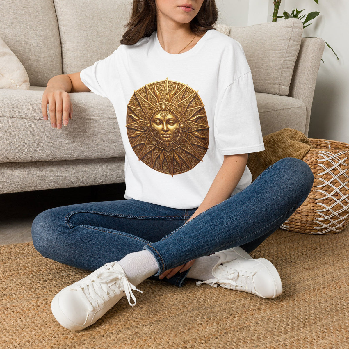 White t-shirt featuring a bronze sun face medallion graphic on the chest