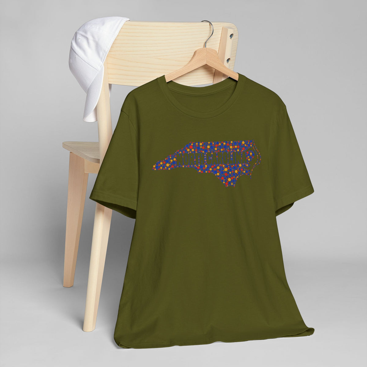 Olive green T-shirt with colorful dotted North Carolina outline graphic