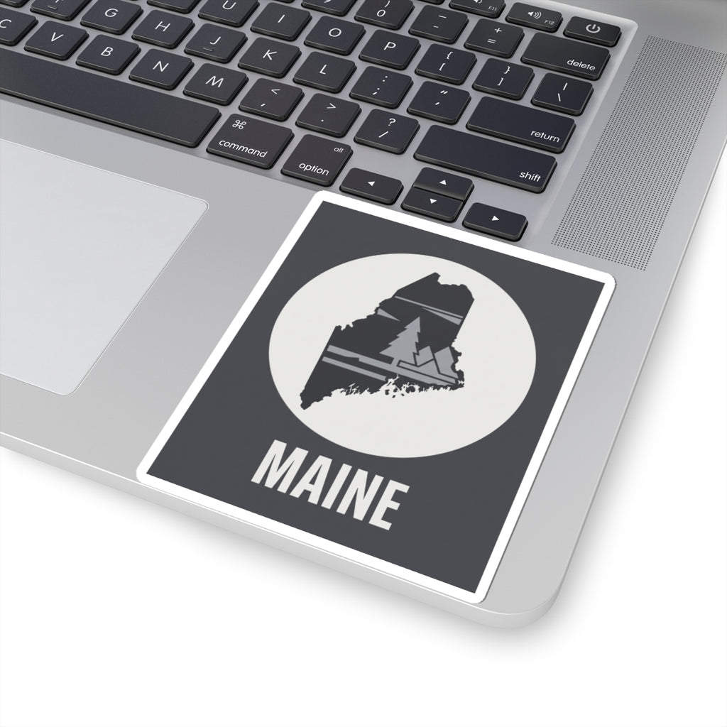 Rectangular Maine sticker with circular cream emblem, pine tree map and 'MAINE' lettering.