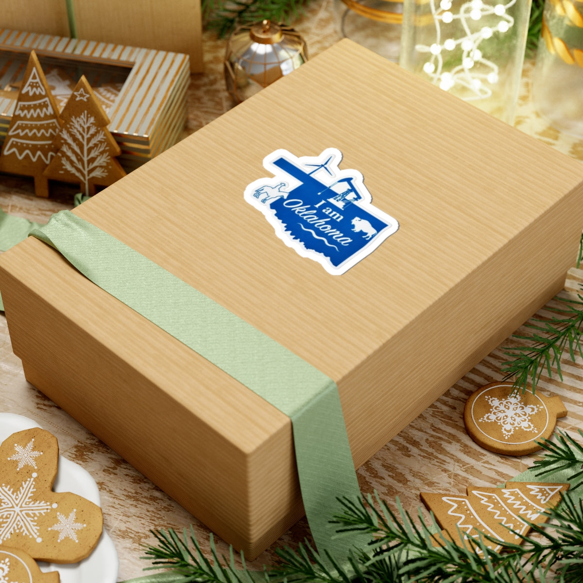 Blue “I am Oklahoma” sticker on a gift box, with airplane and oil rig graphic