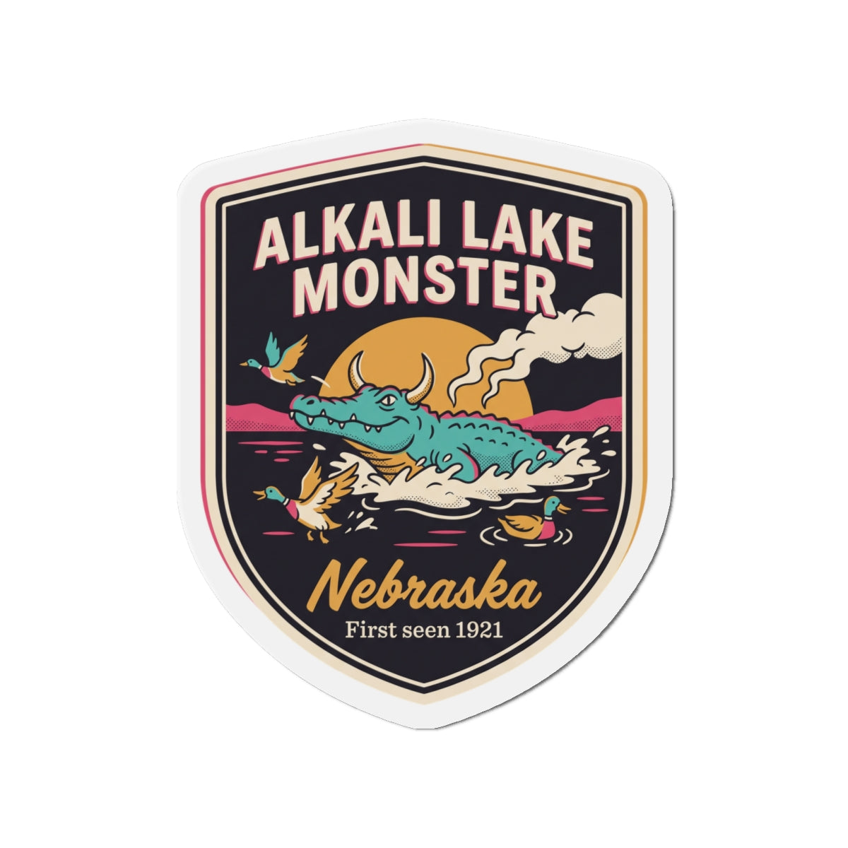 Shield-shaped die-cut magnet with teal creature artwork, smoke, and “Nebraska” lettering