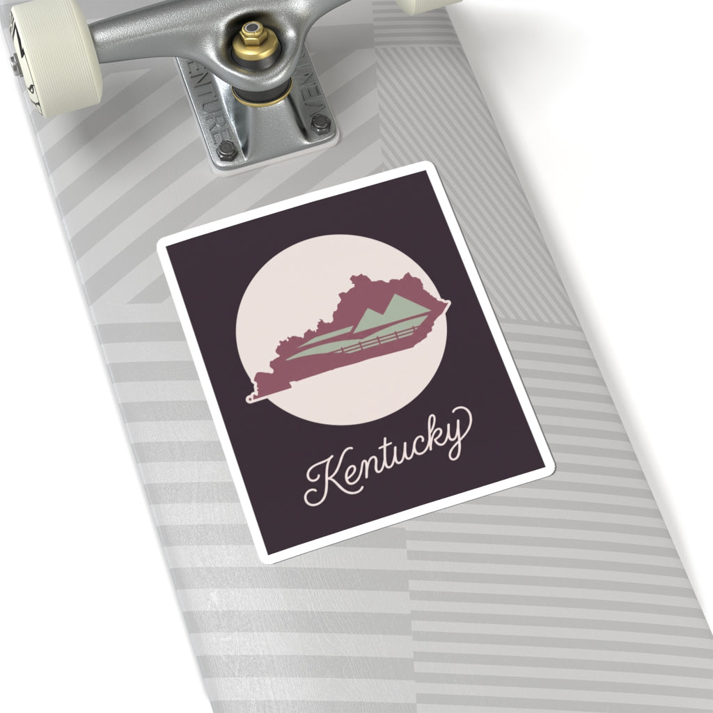 Kentucky silhouette vinyl sticker with white circle, mauve map, and cursive Kentucky text
