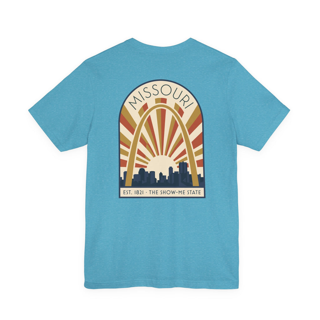Light aqua Missouri sunrise art deco T-shirt with arch skyline graphic and “MISSOURI” text.