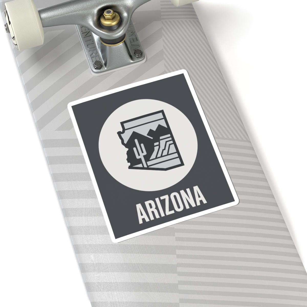 Arizona badge sticker angled: dark square with white circle desert cacti logo and ARIZONA text