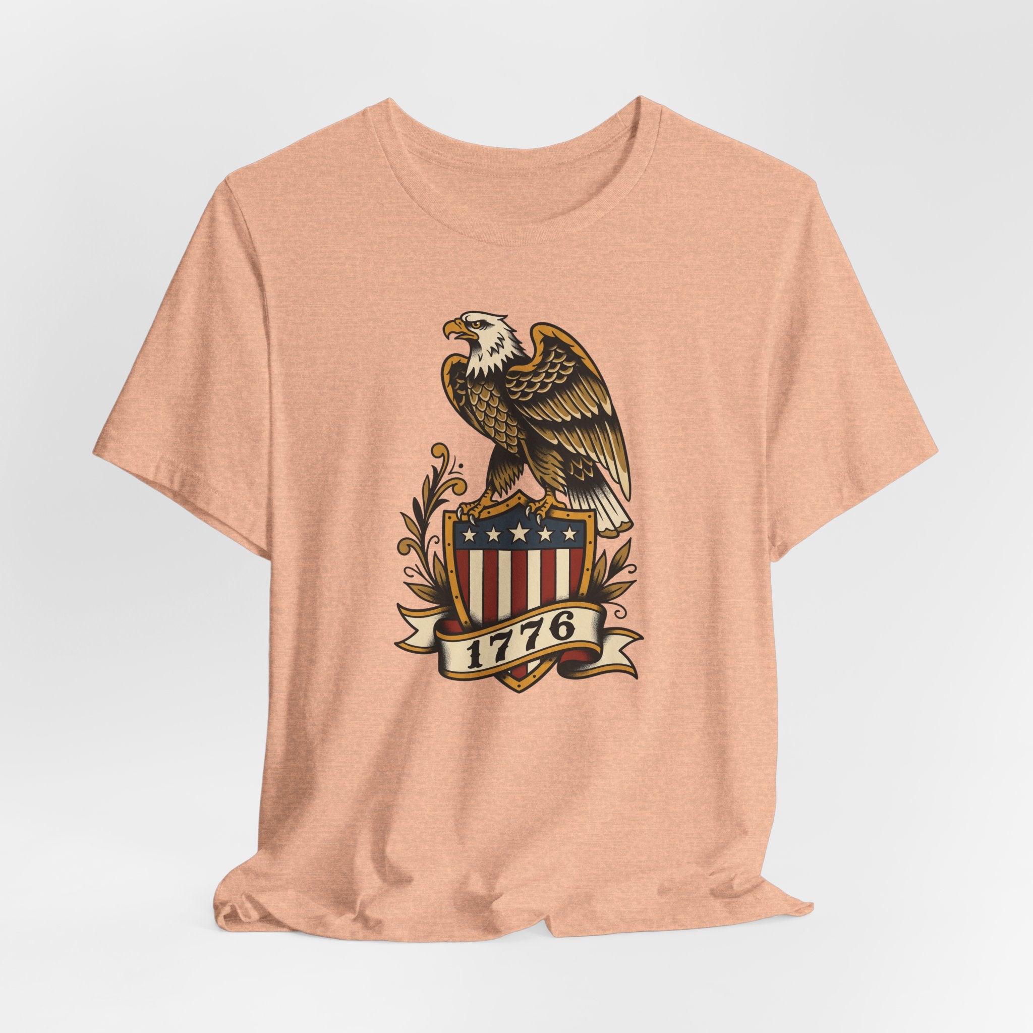 Peach heather crewneck T-shirt featuring bald eagle shield graphic with stars and 1776