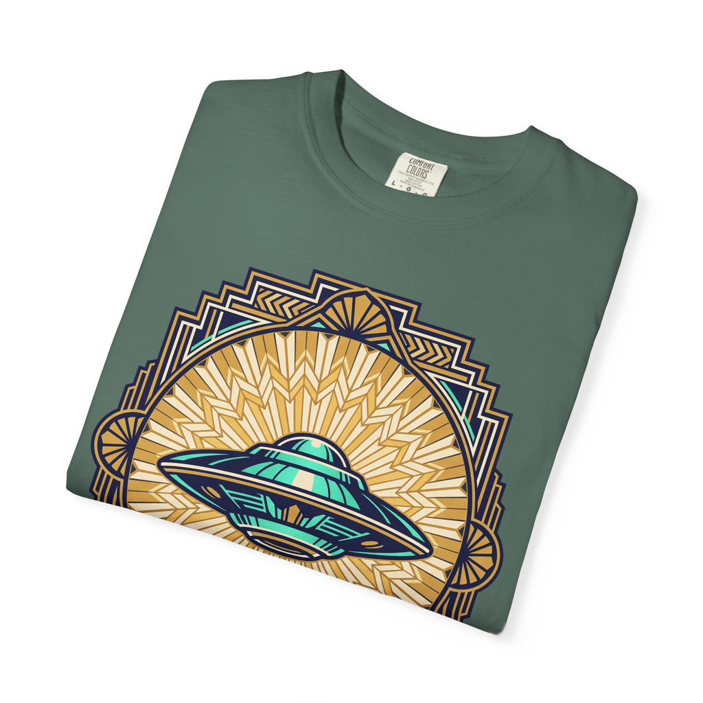 Teal crew-neck T-shirt with a retro UFO graphic and geometric sunburst border.