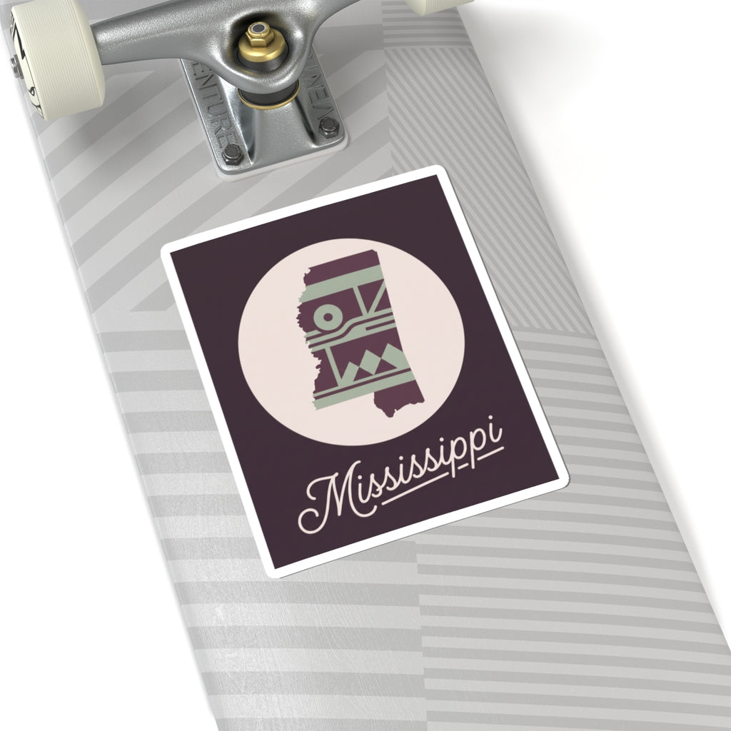 Mississippi sticker decal on grey-striped surface; purple square border with circular emblem