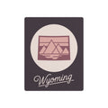 Square mauve metal wall art with oval landscape emblem and script “Wyoming”