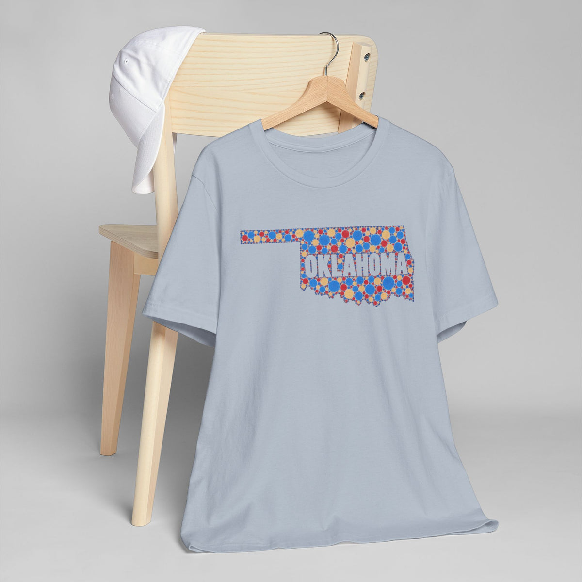 Light blue T-shirt with colorful Oklahoma outline floral graphic and Oklahoma text